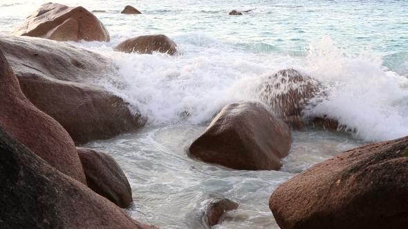 Waves Breaking On Granite Boulders In Beach Of Anse Lazio