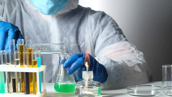 Chemist in laboratory works in chemical reagents