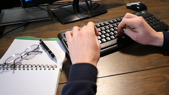 Male Hands Typing On A Keyboard alt