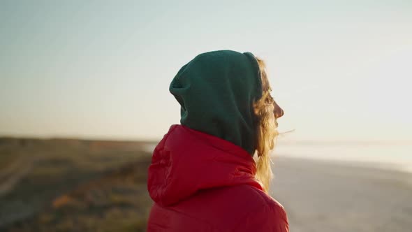 Slow Motion Close Up Portrait of Young Adult Woman Traveler Looking at Sunrise at Sea Beach