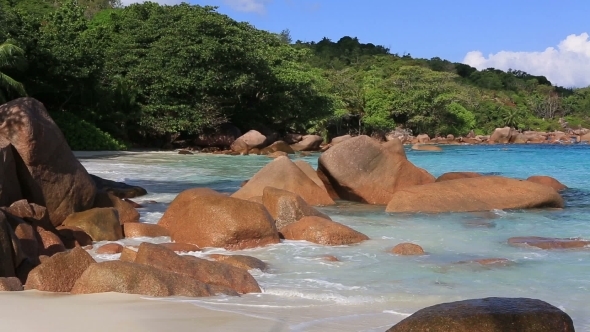 Waves Breaking on Granite Boulders in Beach of Anse Lazio.