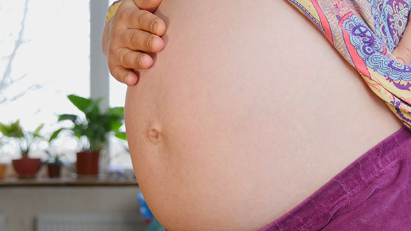 Pregnant Woman Showing Her Belly