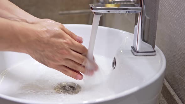 Adult Male Washing His Hand Using Antibacterial Soap