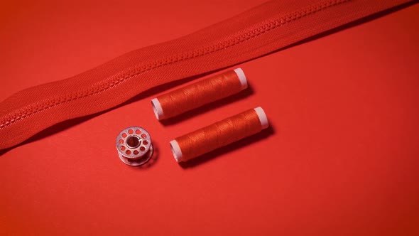 Threads and Zipper on a Red Minimalistic Background