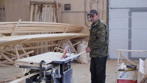 Carpenter Working with Circular Saw Woodworking Machine