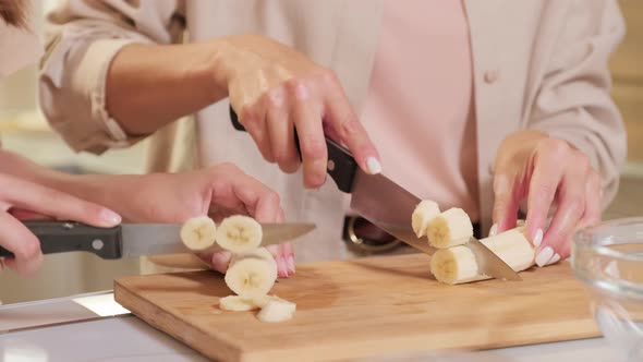 Cutting Banana Slices In Kitchen