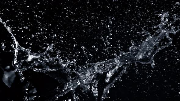 Super Slow Motion Shot of Side Water Splash Isolated on Black Background at 1000Fps.