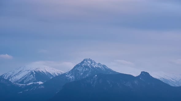 Cold cloudy april landscape with mountains, melting snow in the mountains,