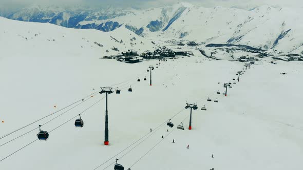 Snowy Mountain Peaks and a Functioning Cable Tramway