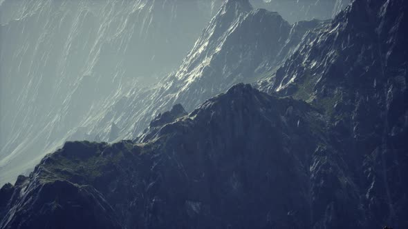 Rocks Covered with Grass Under a Cloudy Sky