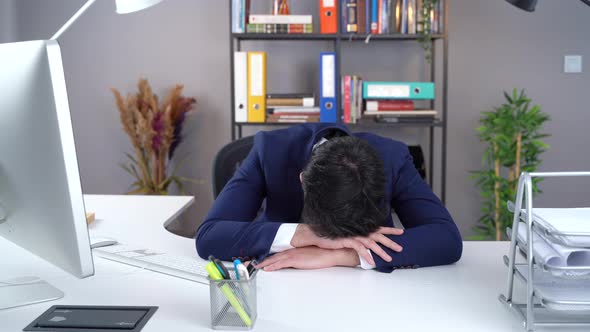 Office worker sleeping at computer.