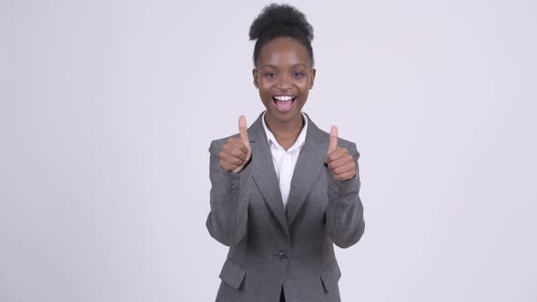 Young Happy African Businesswoman Looking Excited and Giving Thumbs Up