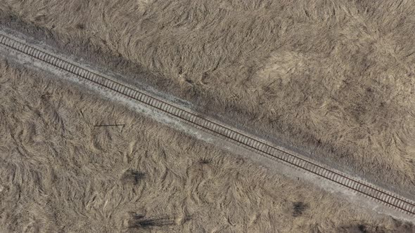 Descending on railroad track without trains 4K aerial video