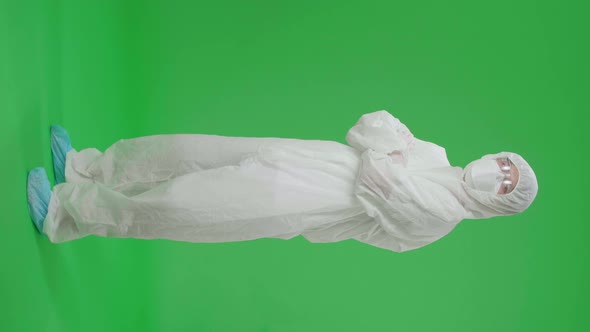 Full Body Of Male Wear Protective Uniform Ppe Pose With Arms Crossed In Green Screen Studio