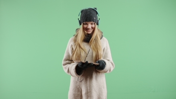 Happy Girl Listening To Music on Headphones Winter In The Winter