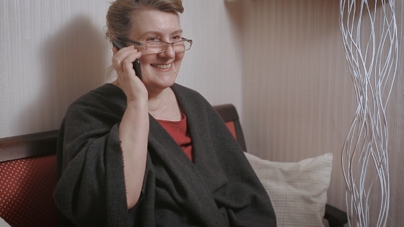 Portrait Of a Mature Woman Talking On Telephone