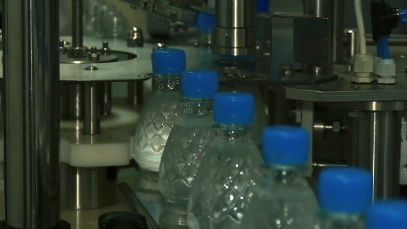 Plastic Bottles Move Along The Conveyor