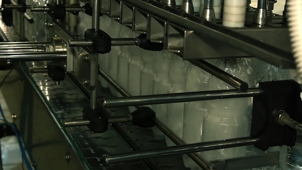 Plastic Bottles Filled With Water on The Conveyor