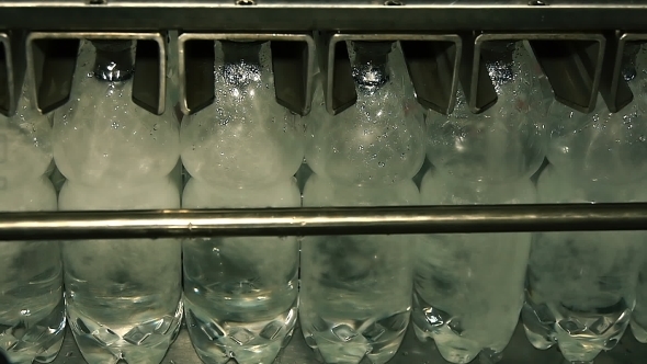 Plastic Bottles Filled With Water On The Conveyor