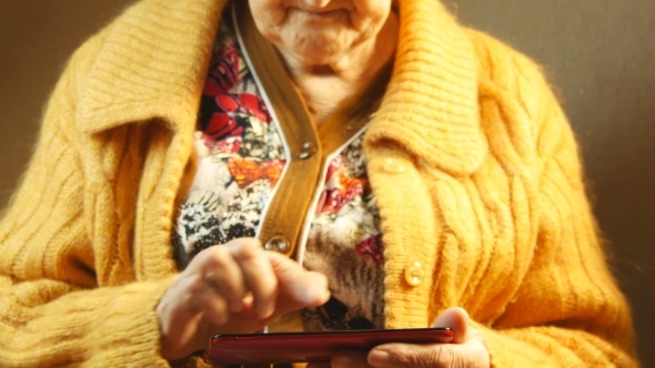 Old Woman And Electronic Tablet