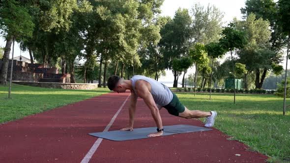 Sportsman Working on His Sixpacks with Rock Mountain Exercise on Fitness Mat Outdoor Sporting