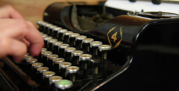 Woman Typing On Vintage Typewriter