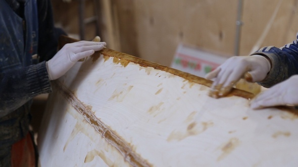 The Carpenter Seals the Joints of the Boat at the Shipyard