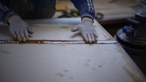 The Carpenter Seals the Joints of the Boat at the Shipyard