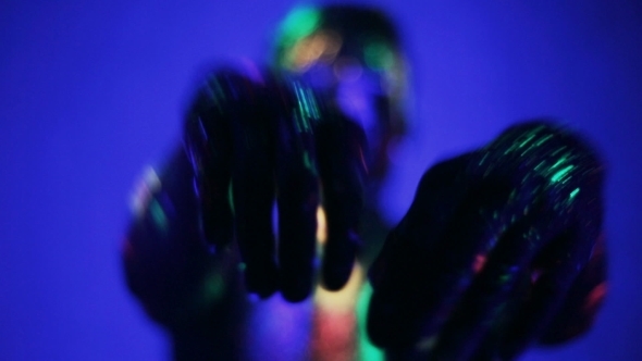 Man's Hands Glow In Ultraviolet Light