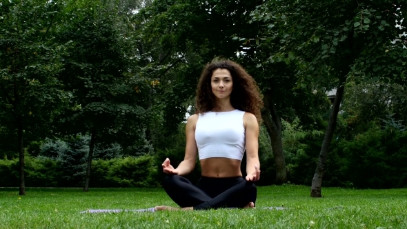Woman Enjoying Doing Yoga In Park