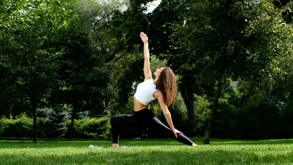 Sporty Woman Stretching And Prepearing Doing Yoga In Park