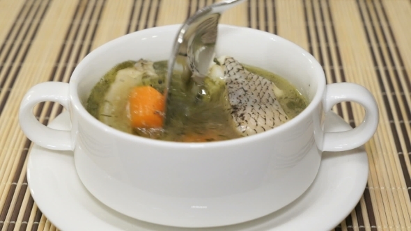 Fish Soup From The Macrourus Fish Is Stirred Using a Spoon In a Tureen