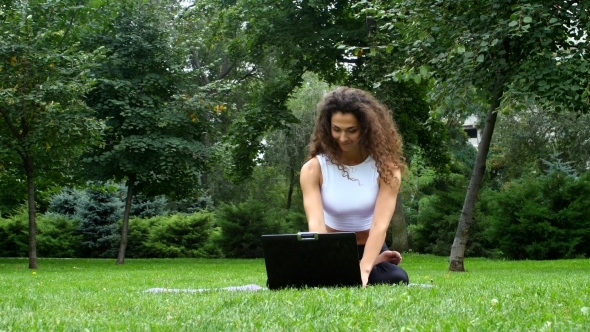 Woman Doing Yoga In Park And Work On Laptop 1