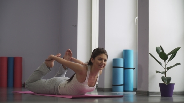 Woman Doing   Exercises For Flexibility In Gym On The Floor