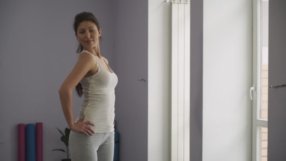  Beautiful Woman Looking at Herself in Mirror in Gym