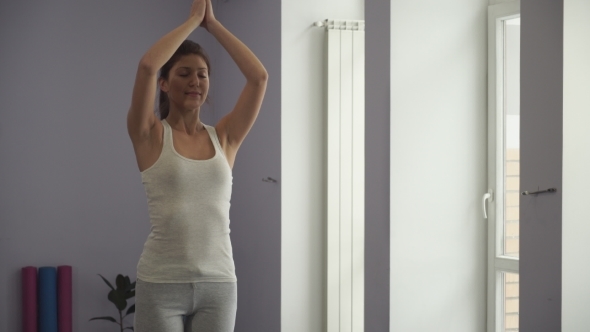 Woman Doing Relaxing Yoga Exercises After Workout