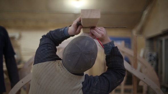 Carpenter Makes Measurements and Mark with a Pencil