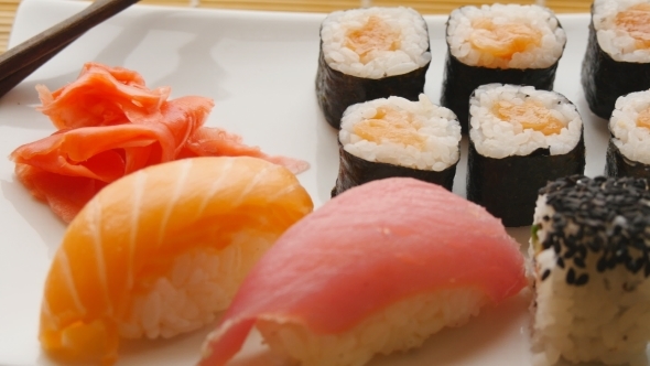 Various Sushi On White Plate On Wooden Background