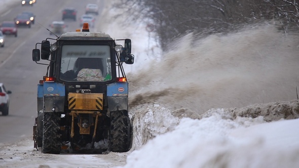 Tractors Of Road Service Clean Up The Snow From The Roadside