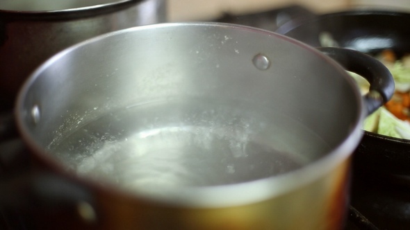 Water is Heated in a Saucepan on the Gas Stove