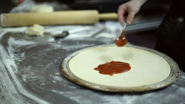 The Chef Smears Ketchup on the Dough