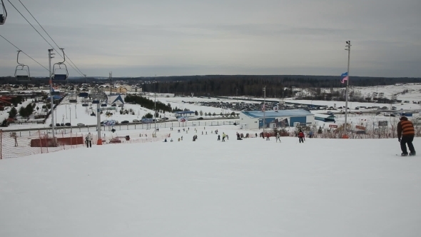 Skiers And Snowboarders Skiing Downhill alt