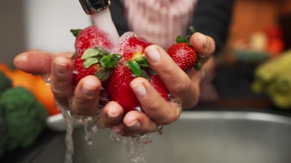 Woman Hands Washing Strawberries in the Kitchen