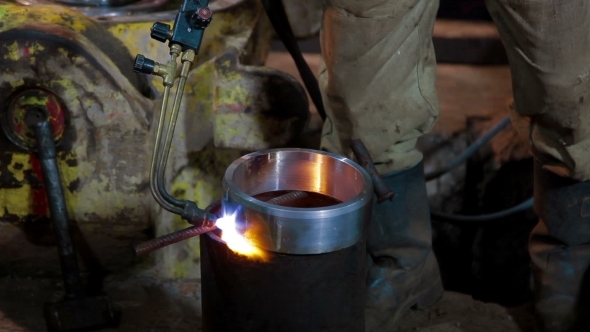Human Warms Up The Mold Of Metal By Burner