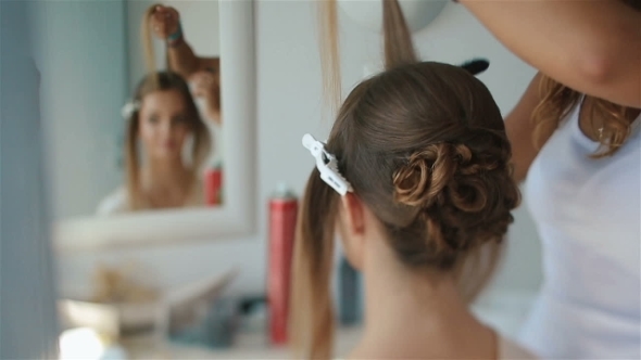 Attractive Brunette Bride Looks In The Mirror While Doing Her Hairstyle