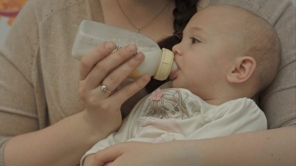 Cute Baby Eating Milk From Bottle