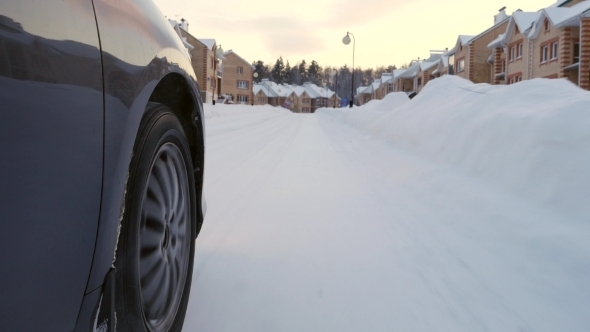 Car's Wheel On Winter Road