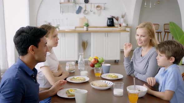 Family Giving Highfive During Breakfast