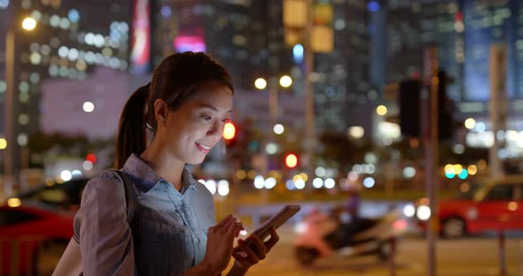 Woman use of mobile phone online at night