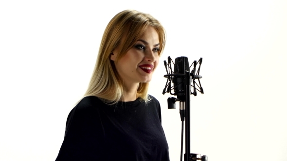 Blonde Girl Signing In Microphone And Smiling